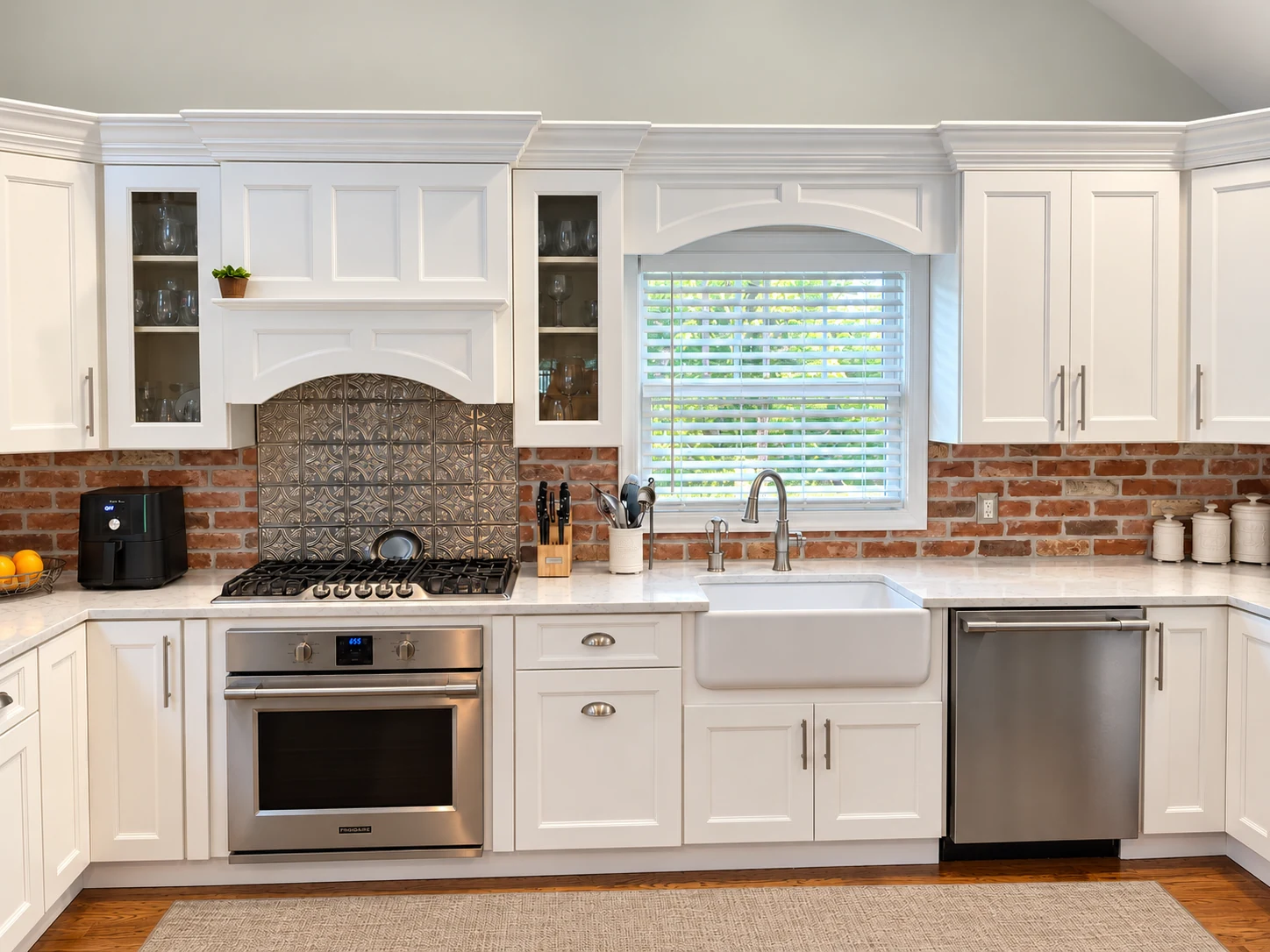 White kitchen with brick and pressed-metal backsplash