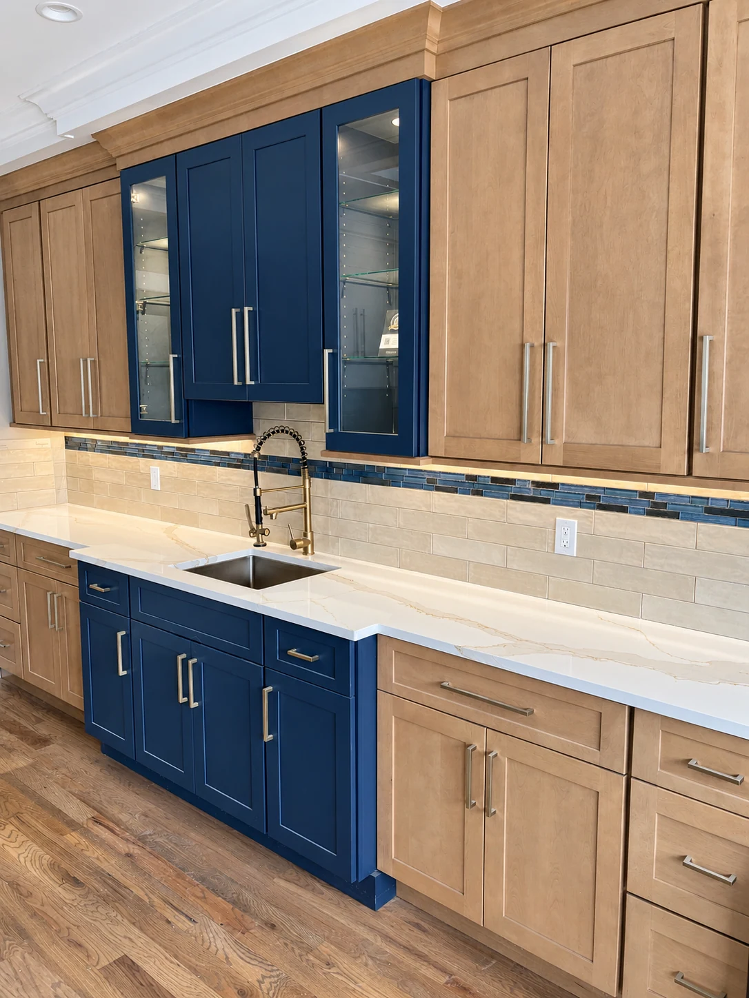 Navy and wood cabinetry with a sink